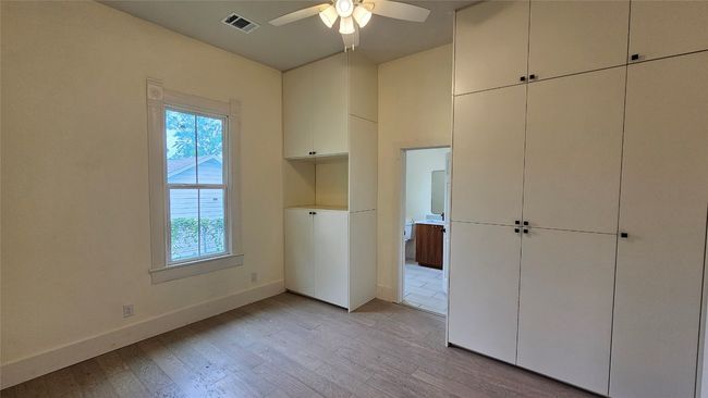 Unfurnished bedroom featuring light wood finished floors, baseboards, and ceiling fan | Image 5