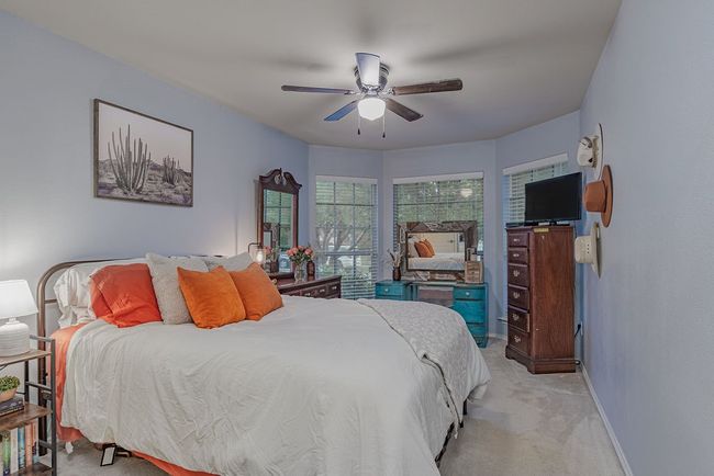 Bedroom with baseboards, a ceiling fan, and light colored carpet | Image 4