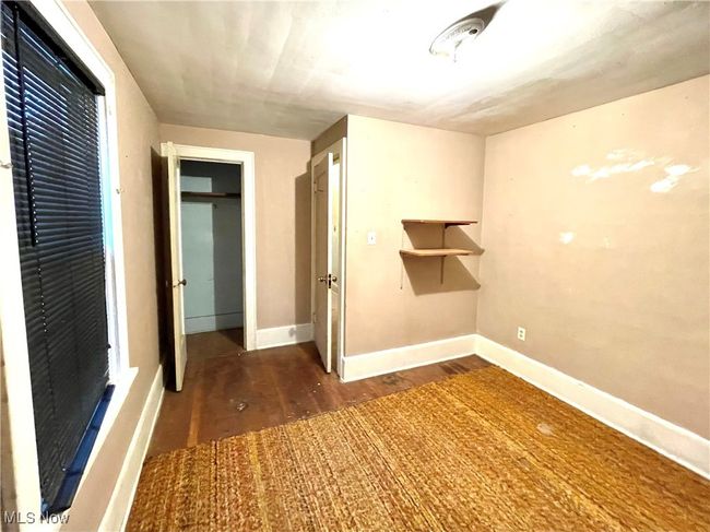 Unfurnished bedroom with wood finished floors and baseboards | Image 14
