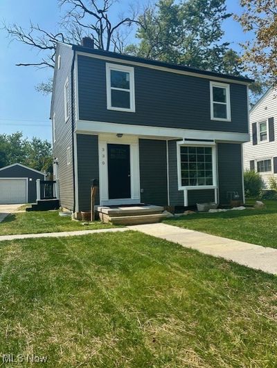 View of front of house featuring a front lawn, a garage, and an outbuilding | Image 2