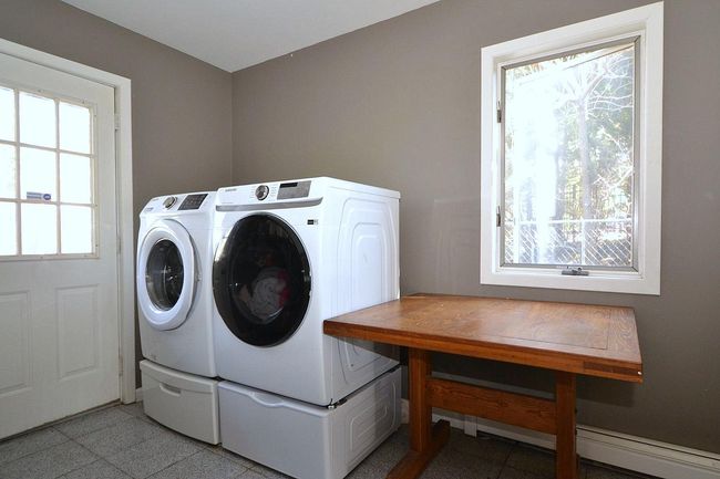 Laundry room with washing machine and clothes dryer and laundry area | Image 11