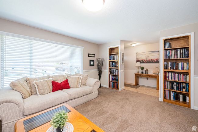 Carpeted living area with baseboards | Image 14