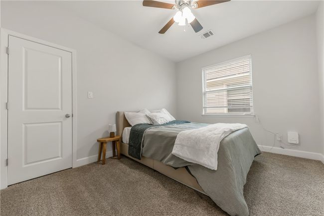 Bedroom with carpet flooring and a ceiling fan | Image 10
