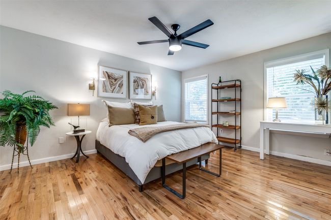 Bedroom with light wood-style flooring and ceiling fan | Image 8