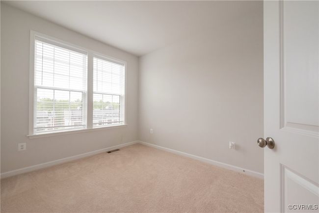 Unfurnished room featuring light carpet, baseboards, and visible vents | Image 40