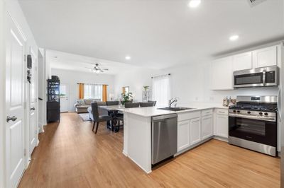 This space is elegantly enhanced with striking vinyl flooring, complemented by recessed lighting and an oversized ceiling fan designed to optimize airflow. | Image 3