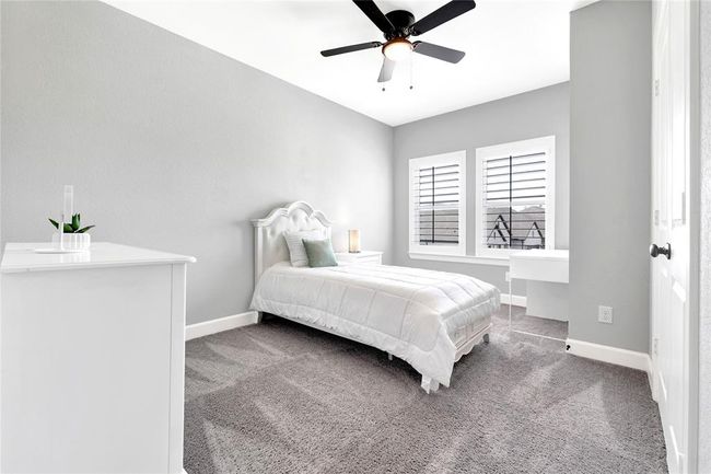 Spacious Secondary bedroom upstairs with plantation shutters and large closet | Image 43