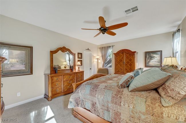 Bedroom featuring a ceiling fan, baseboards, and visible vents | Image 26