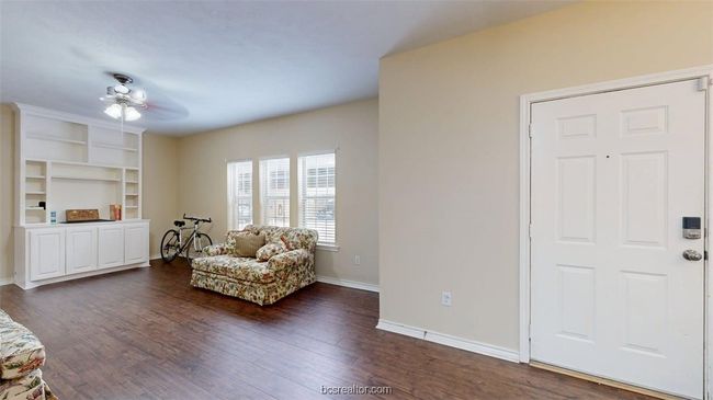 Sitting room with baseboards and dark wood-type flooring | Image 4