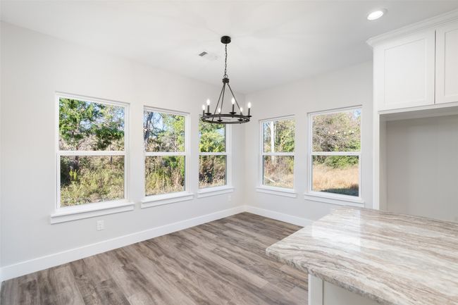 Unfurnished dining area featuring hardwood / wood-style flooring and an inviting chandelier | Image 16
