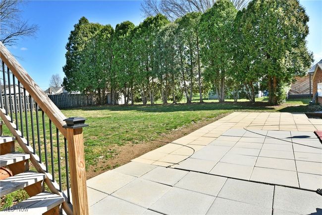 View of yard featuring fence and a patio area | Image 14