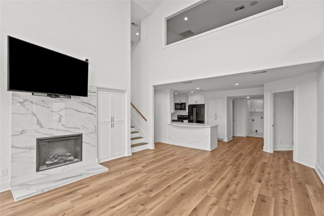 Fireplace features sleek quartz, new flooring and modern touches throughout | Image 9