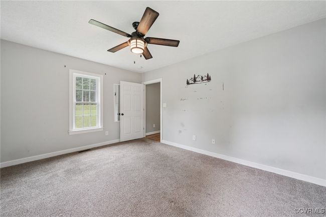 Spare room with carpet flooring, baseboards, and a ceiling fan | Image 8