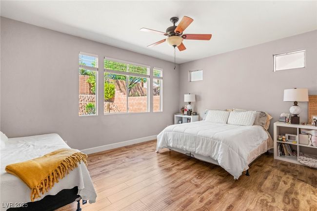 Bedroom featuring baseboards, wood finished floors, and ceiling fan | Image 22