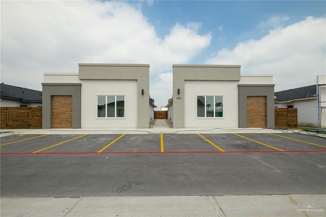 View of property featuring uncovered parking and fence | Image 25