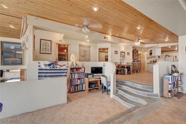 Living area with wooden ceiling, ceiling fan, recessed lighting, and tile patterned flooring | Image 21