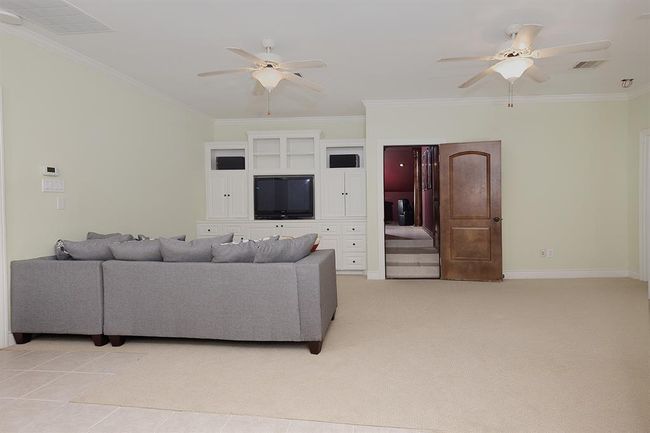 This 3rd floor living area with built-ins off the media room has an adjacent kitchenette | Image 40