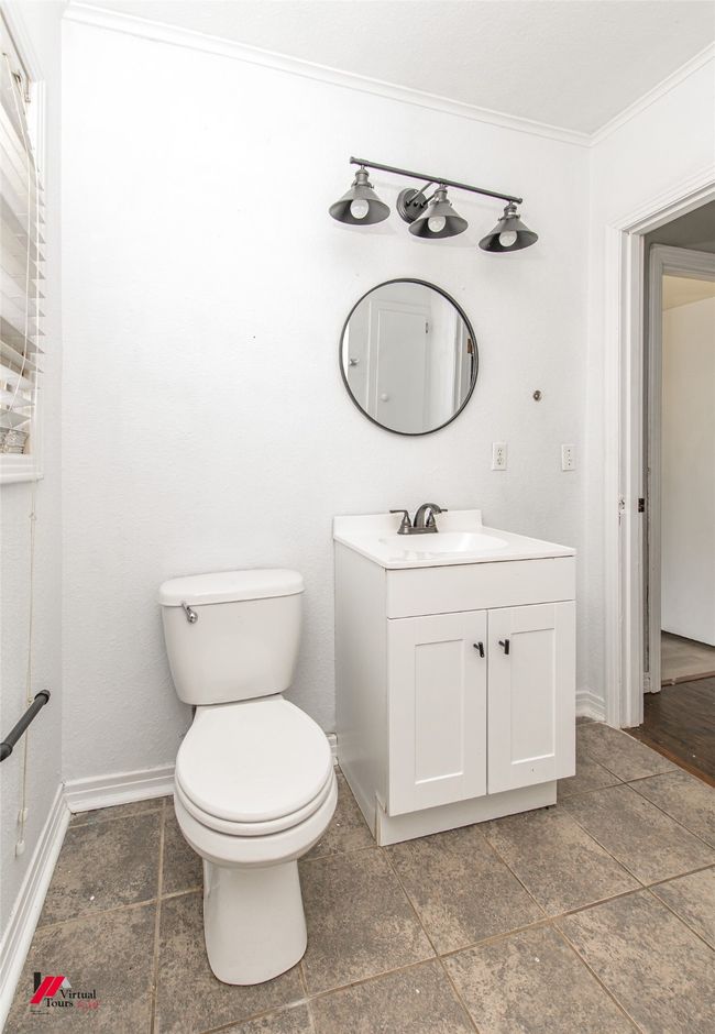 Bathroom featuring toilet, vanity, ornamental molding, and baseboards | Image 6
