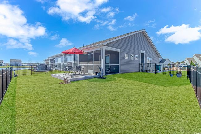 Back of house with a sunroom and a yard | Image 23