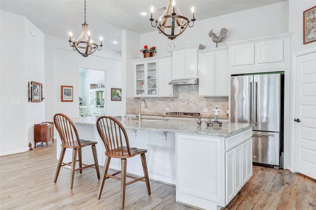 Above the expansive island, two eye-catching pendant lights add a touch of elegance and instantly draw your attention. | Image 7