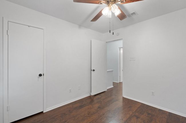 Unfurnished bedroom featuring wood finished floors and a ceiling fan | Image 28