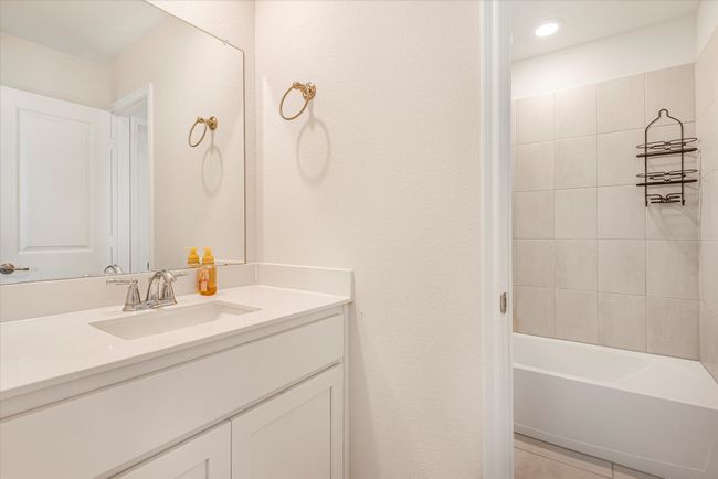 Bathroom with tile patterned floors, tub / shower combination, and vanity | Image 21