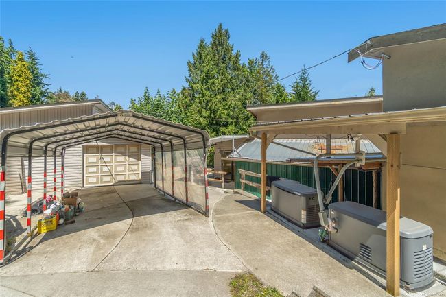 View of parking with a detached garage | Image 76