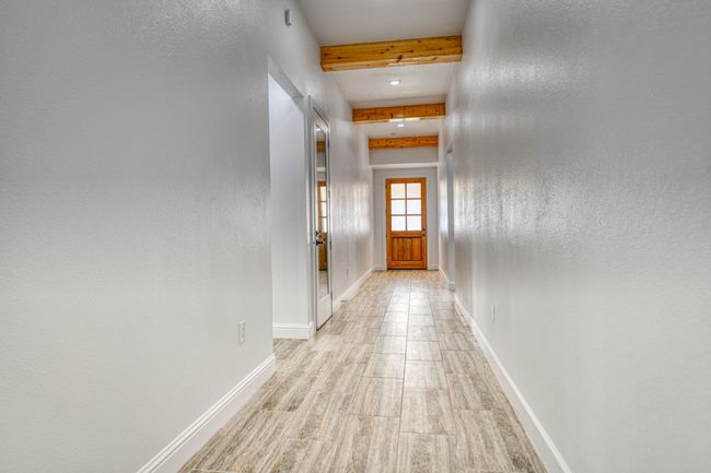 Hall featuring beam ceiling and light hardwood / wood-style floors | Image 14