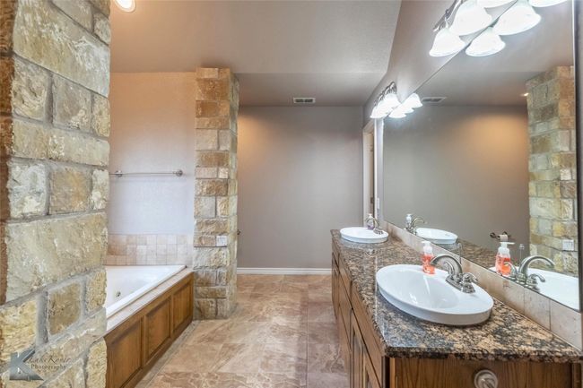 Full bathroom with a whirlpool tub and double vanity | Image 15