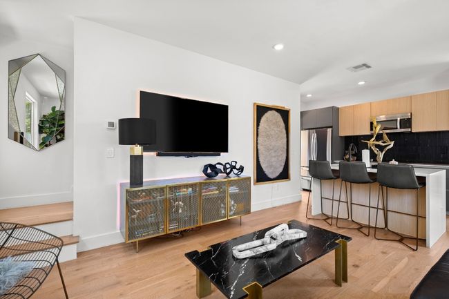 Living area featuring light wood-style flooring and recessed lighting | Image 8