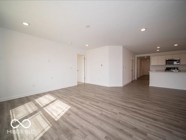 unfurnished living room featuring recessed lighting, baseboards, and light wood finished floors | Image 16