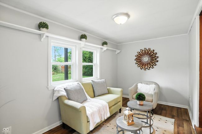 sitting room featuring wood finished floors and crown molding | Image 19