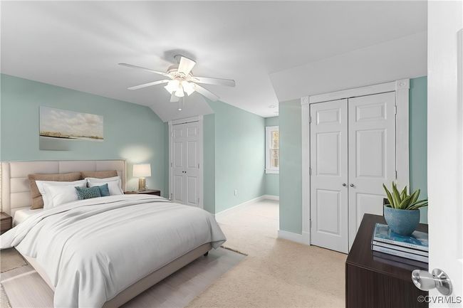 Bedroom with two closets, light colored carpet, and a ceiling fan | Image 16