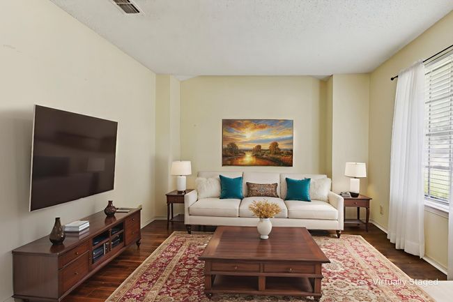 Living area with dark wood-style flooring and a textured ceiling | Image 4