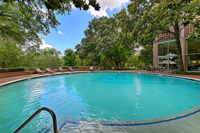 Community pool featuring view of wooded area | Image 28