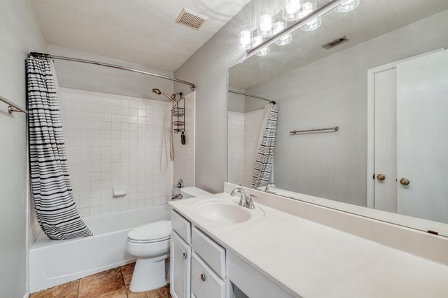 Full bathroom featuring shower / bath combination with curtain and vanity | Image 29