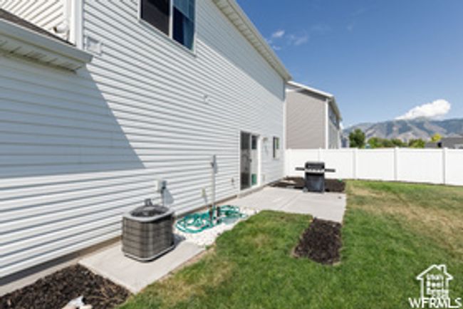 View of yard featuring a mountain view and a patio area | Image 15