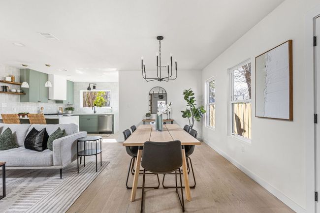 Dining room featuring a chandelier and light wood finished floors | Image 11