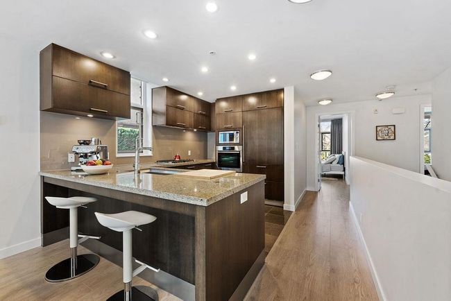 Kitchen with a peninsula, modern cabinets, and High end stainless steel appliances | Image 21