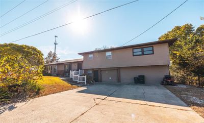 Split level home featuring a garage | Image 2