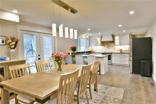 Dining room with light wood-type flooring, french doors, and recessed lighting | Image 12