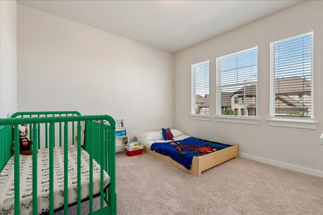 Carpeted bedroom featuring multiple windows and baseboards | Image 34