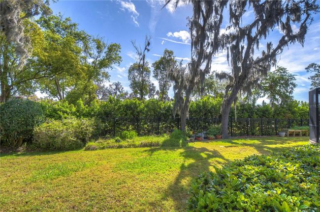 Embrace the Florida lifestyle with this beautifully landscaped backyard oasis, featuring a spacious screened lanai perfect for sun-drenched afternoons or starry evening gatherings. | Image 37