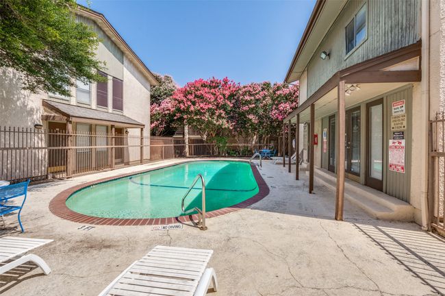 Community pool with a fenced backyard and a patio | Image 24