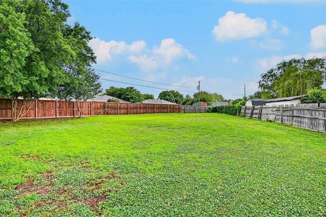 View of fenced backyard | Image 21