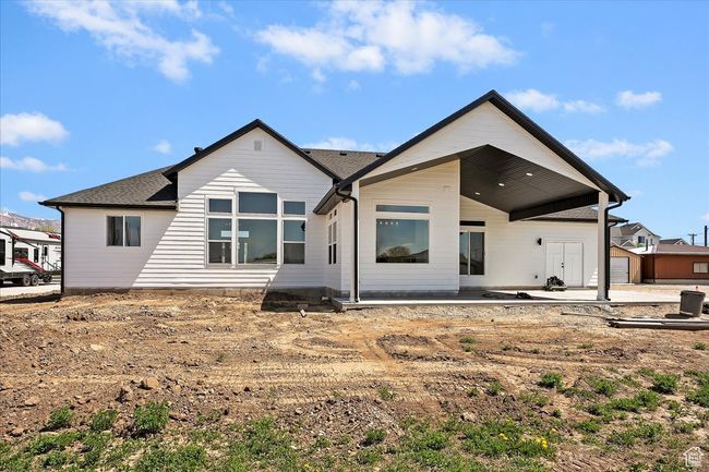 Back of property with a shingled roof and a patio | Image 19
