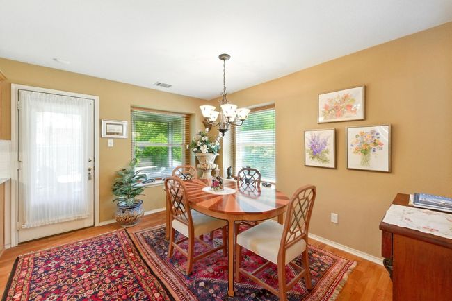 Dining space with a chandelier, light wood-style floors, and baseboards | Image 9