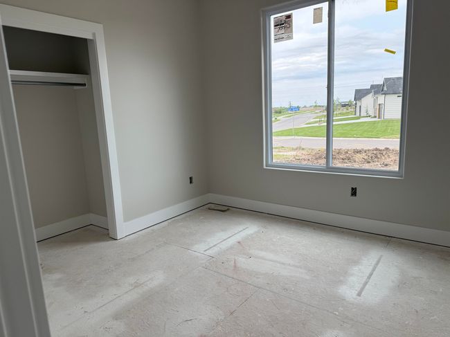 Unfurnished bedroom featuring baseboards and a closet | Image 4