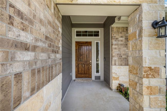 Entrance to property featuring brick siding and stone siding | Image 4