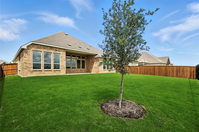 Rear view of house with a fenced backyard, brick siding, and roof with shingles | Image 27